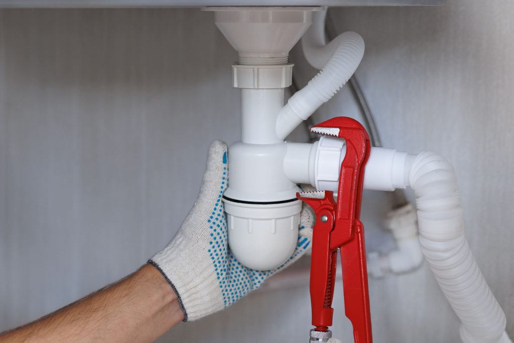 professionnel qui resserre un siphon